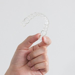 Closeup of patient holding clear aligner