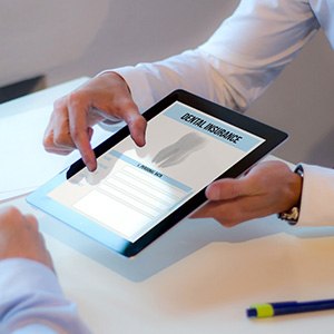Patient reviewing dental insurance form on tablet