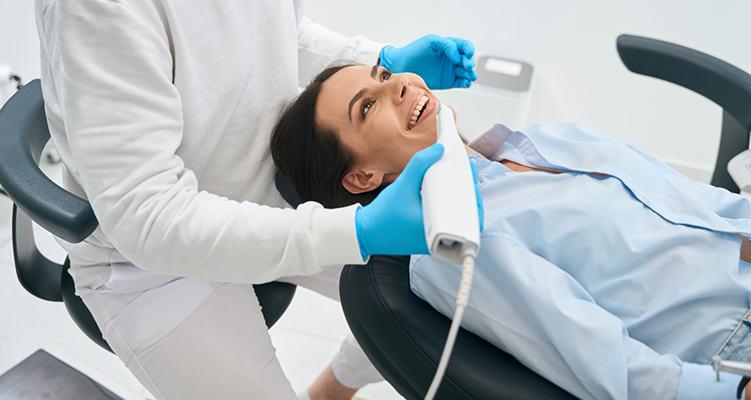 Dental patient having her dentist take digital impressions of her teeth