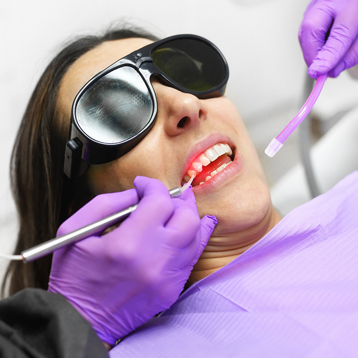Dental patient having her gums treated with a soft tissue laser