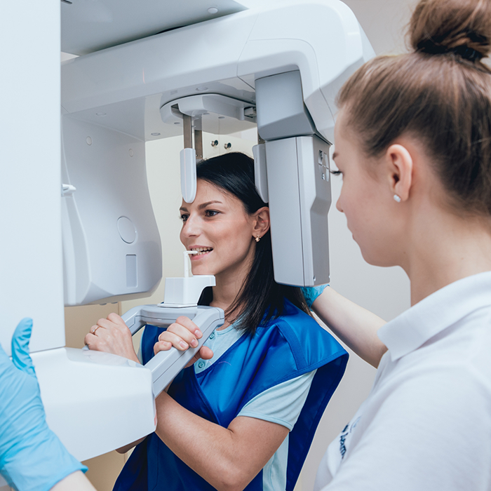 Dental patient getting a CT cone beam scan of her mouth and jaw