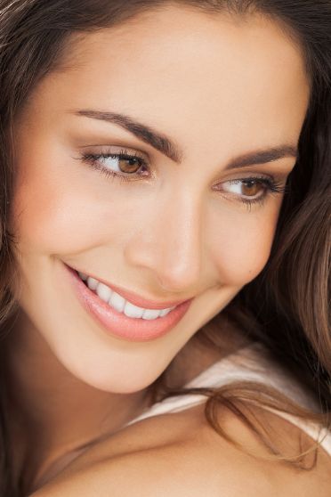Smiling brunette woman looking off to the side