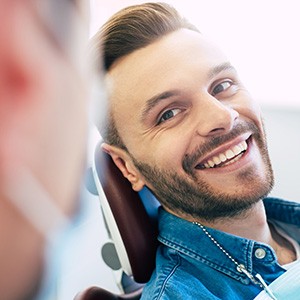 Man smiling at his dentist in the treatment chair
