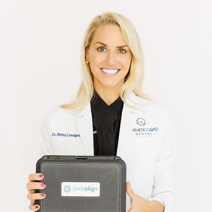 Doctor Lundgren holding an Invisalign kit