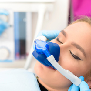 Dental patient with a nitrous oxide mask over her nose