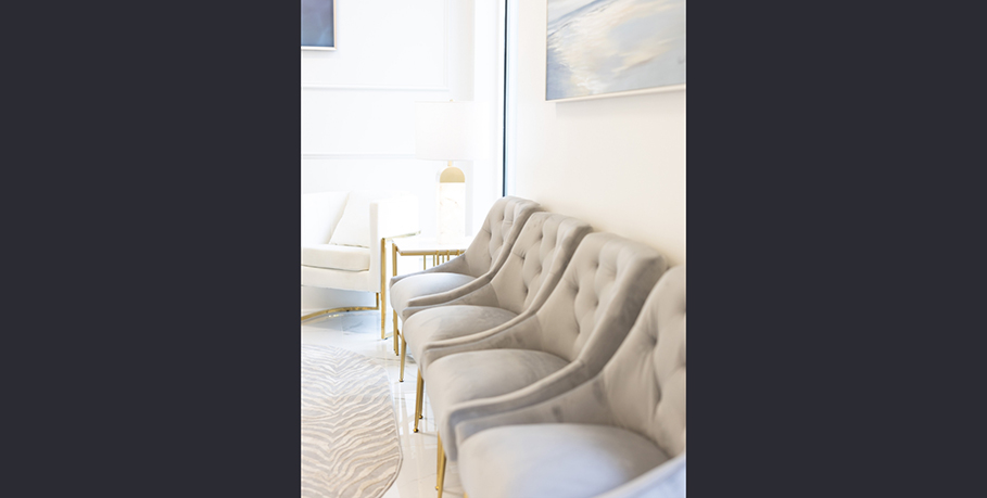Row of soft gray chairs in the waiting area