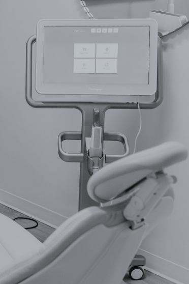 Monitor screen next to a dental treatment chair