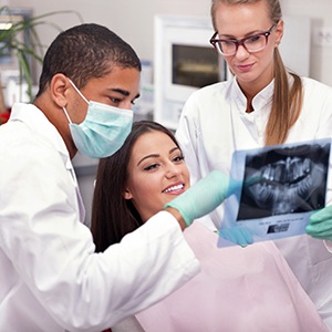 Dentist reviewing X-ray with patient