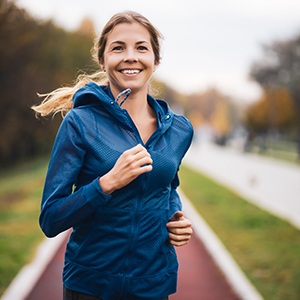 Woman smiling while jogging outside