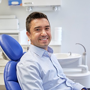 Patient smiling while sitting in treatment chair