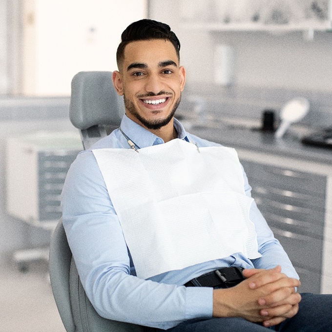 Patient smiling while sitting in treatment chair