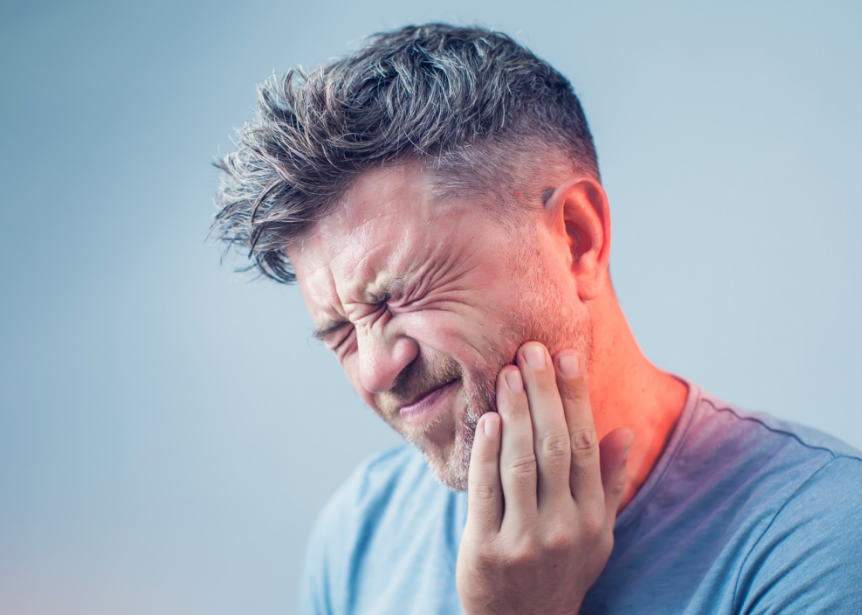 Man holding jaw in pain